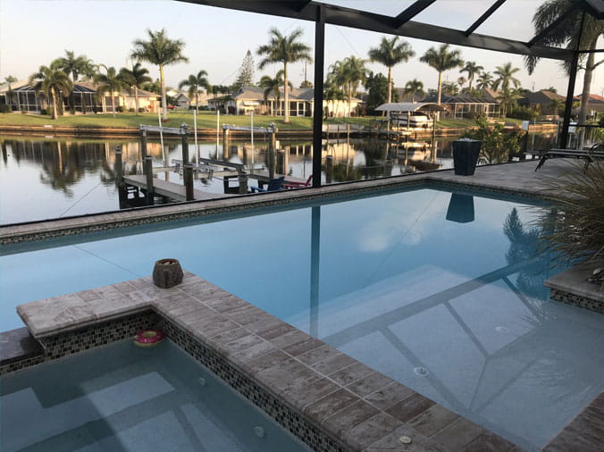 Covered indoor pool in Florida with palm trees in the background